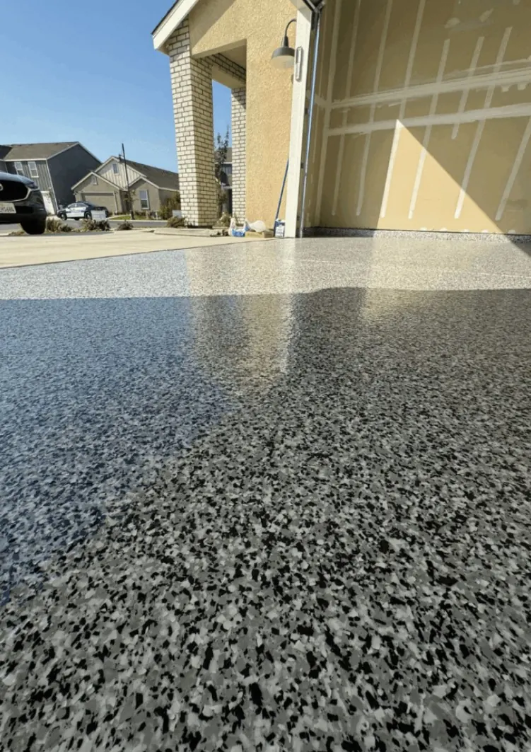 Sunlit gray flake garage floor shown as a service example for Prosper, Texas